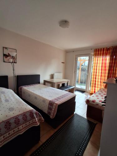 a hotel room with two beds and a table at Wandlitz-Pension Dampflok in Wandlitz