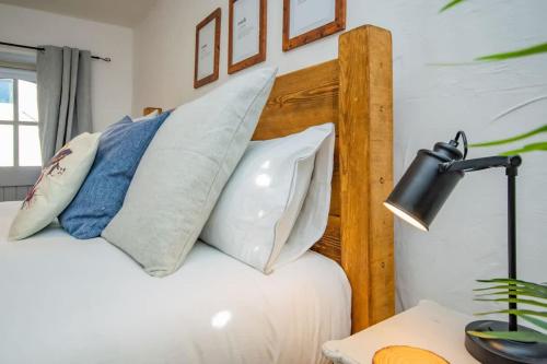 a bedroom with a bed with pillows on it at Cosy Farm Conversion In The Heart Of Pembrokeshire in Pembrokeshire