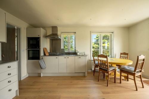 a kitchen with a table and chairs in a room at Converted Hay-loft with Stunning Countryside Views in Haverfordwest