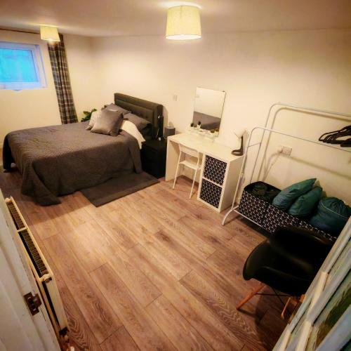 a bedroom with a bed and a desk and a mirror at Treforgan Newydd in Cardigan