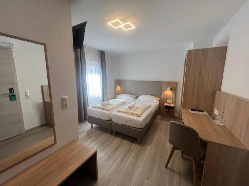 a bedroom with a bed and a large mirror at Hotel Kriemhilde in Worms