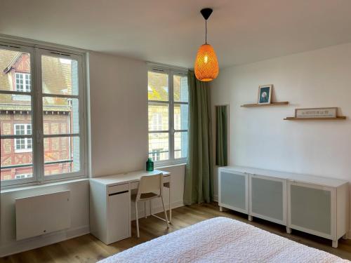 a bedroom with a desk and windows and a bed at Bohemian Rhapsody- Hyper centre Compiègne in Compiègne