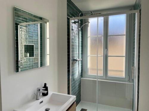 a bathroom with a sink and a glass shower at Bohemian Rhapsody- Hyper centre Compiègne in Compiègne