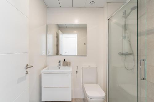 a white bathroom with a toilet and a shower at Casa Cala Serena in Mijas