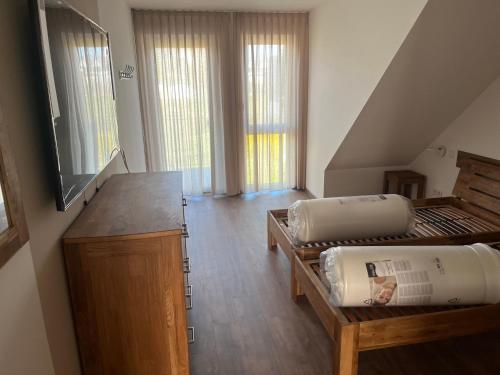 a room with two beds and a tv in it at Apartments Blütenweg in Leichlingen