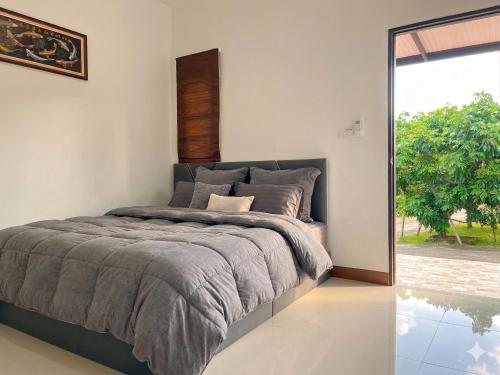 a bedroom with a bed and a large window at Yankoi Mountains view in Chiang Dao