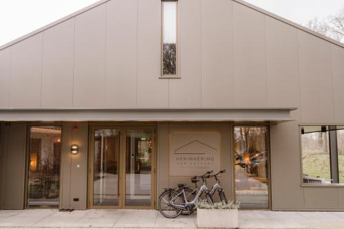 two bikes parked in front of a building at B&B Herinnering aan Brabant in Sint Michielsgestel