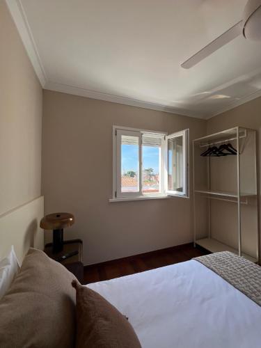 a bedroom with a bed and a window at Private Room in Old Town in Viana do Castelo