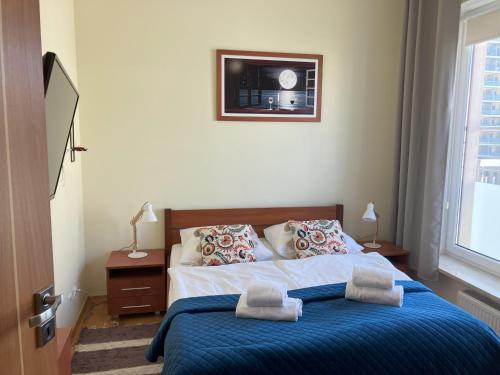 a bedroom with a bed with two towels on it at Aquamarina Turkus Apartament 253 in Międzyzdroje