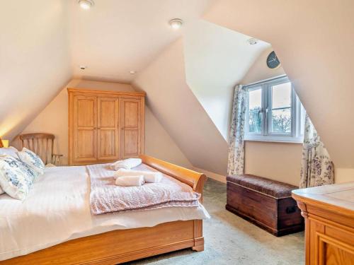 a attic bedroom with a bed and a window at 1 Bed in Sherborne oc-93804 in Yetminster