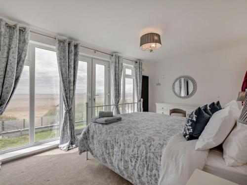 a bedroom with a bed and a large window at 3 Bed in Burnham-on-sea oc-92964 in Brean