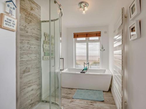 a bathroom with a bath tub and a sink at 3 Bed in Burnham-on-sea oc-92964 in Brean