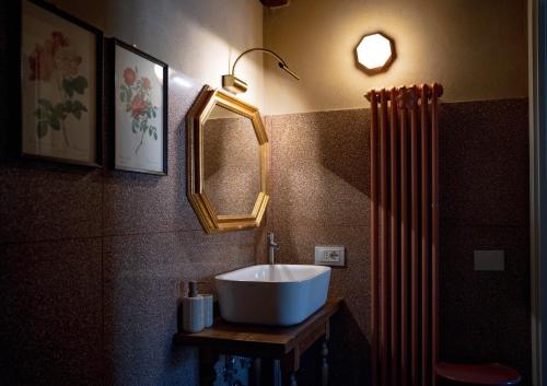 a bathroom with a sink and a mirror and a heater at Casa in Campagna Casagori in Pienza