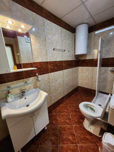 a bathroom with a sink and a toilet at Stunning Beach View Apartment in Ravda