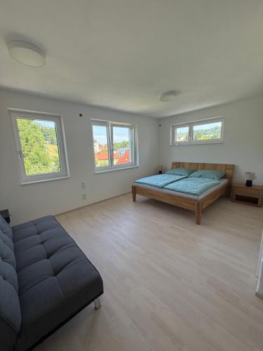 a large white room with a bed and windows at Ferienwohnung Bad Schallerbach in Bad Schallerbach