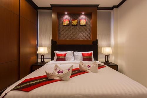 a bedroom with a large bed with three bowls on it at The Best Ao Nang Villas in Ao Nang Beach