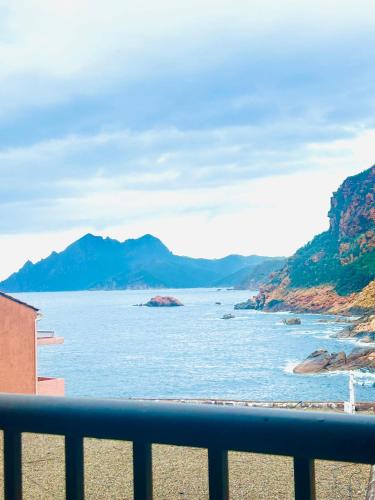 a view of the ocean from a balcony at Hôtel Le Golfe Ecolabel EU in Porto Ota