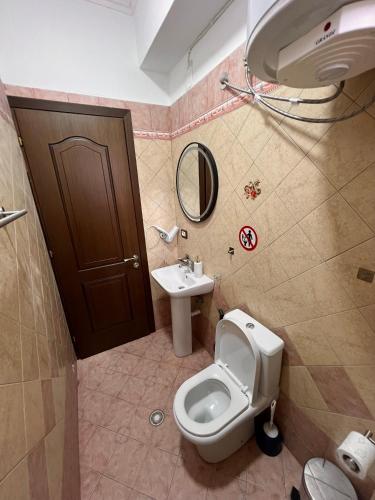 a bathroom with a toilet and a sink at Kapo Apartments in Gjirokastër