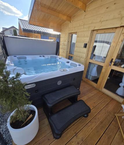 a hot tub sitting on top of a deck at Noclegi AirportPark in Pyrzowice
