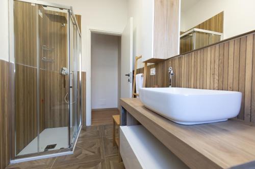 a bathroom with a white sink and a shower at Costa d'Abruzzo - Casa Vacanza in Montesilvano