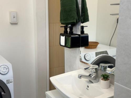 a bathroom with a sink and a washing machine at Cozy Corner 41 in Ruse