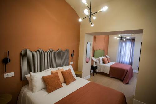 a hotel room with two beds and a mirror at Casa Lombarda in Mérida