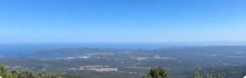 a view of a city from the top of a hill at Chambre Belvédère in Porto-Vecchio