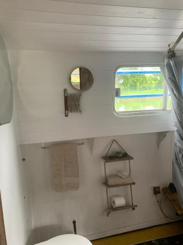 a bathroom with a toilet and a window at Barge in central Cambridge in Cambridge