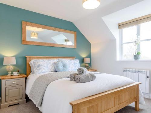 a bedroom with a bed with a mirror on the wall at 2 Bed in York oc-81052 in Helmsley