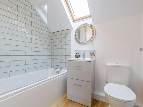 a bathroom with a toilet and a tub and a sink at 2 Bed in York oc-81052 in Helmsley