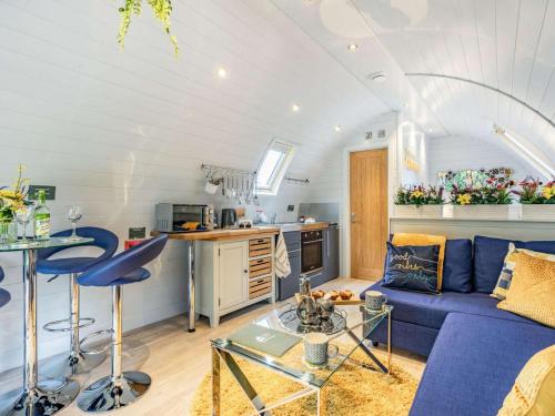 a living room with a blue couch and a kitchen at 1 Bed in Consett oc-87933 in Shotley Bridge