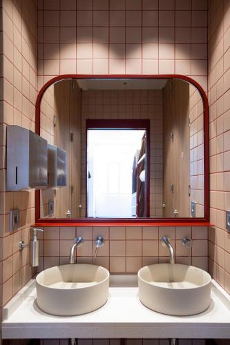 a bathroom with two sinks in front of a mirror at The Central House Valencia Mercado Central in Valencia