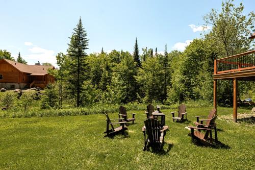 a group of chairs and tables in the grass at Fiddler Lake Resort - Deer 9 in Mille-Isles
