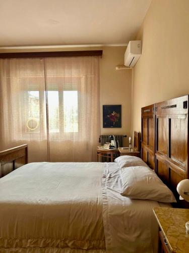 a bedroom with a large bed and a window at Villa Ada in Monsummano Terme