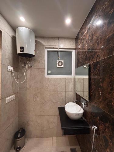 a bathroom with a sink and a mirror at Garden view by Midtown in Katra