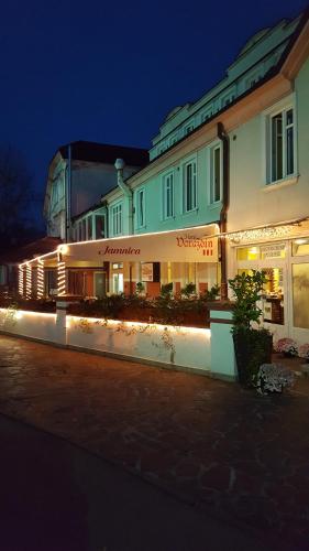 a building with lights in front of it at night at Hotel Varazdin in Varaždin