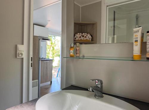a bathroom with a white sink and a mirror at Camping Le Soleil du Verdon in Esparron-de-Verdon