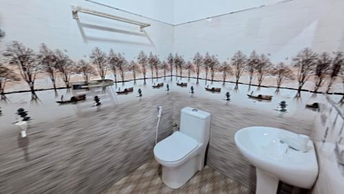 a bathroom with a toilet and a sink at Akshayaam Villa in Kotagala