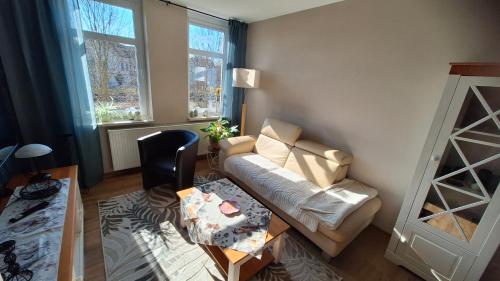 a living room with a couch and a table at Ferienwohnung Heike "Zum Spatzennest" in Mühlhausen