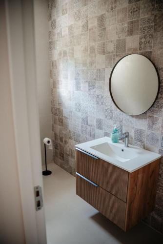a bathroom with a sink and a mirror at Armonia -Rucar in Podu Dîmboviţei