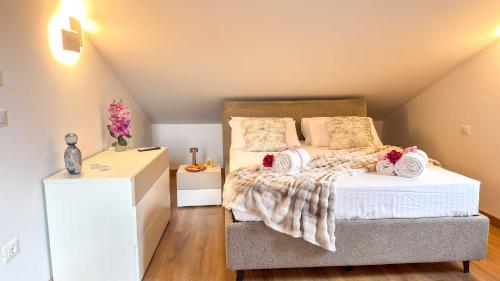 a bedroom with a bed with towels on it at Imperial Golden Suite by Ca-Sa Check in Chioggia