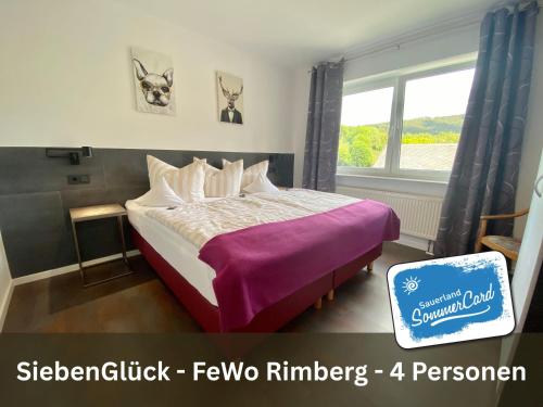 a bedroom with a bed with purple sheets and a window at Siebenglück - 4 FeWo's mit SommerCard in Winterberg