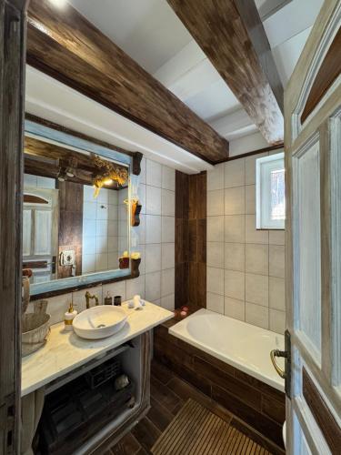 a bathroom with a tub and a sink and a bath tub at Casa di Mare Stegna in Archangelos