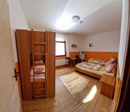 a room with two bunk beds and a window at Penzion Jaroš in Popůvky