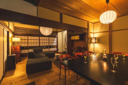 a living room with a dining table and chairs at 城下町の一棟貸し 今来 Konrai - Private-use guesthouse in Matsumoto