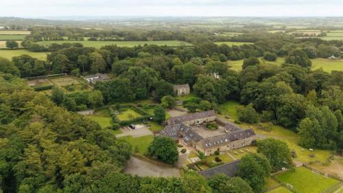 an aerial view of an old mansion in a field at Granary Cottage at Scolton Cottages - Indoor pool in HAW