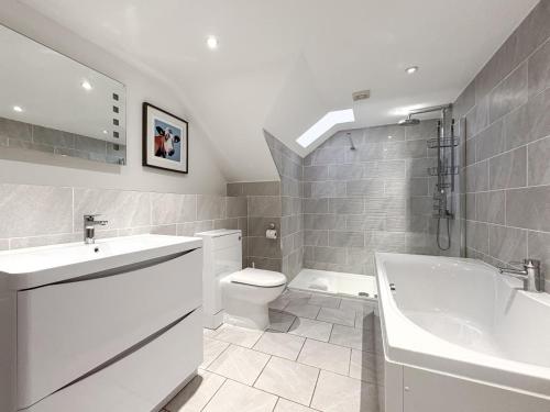 a bathroom with a sink and a toilet and a tub at 4 Bed in Newquay oc-b27906 in Newquay