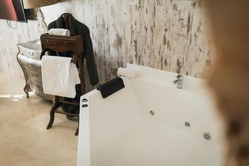 a bathroom with a white sink and a wooden wall at Hotel Sun Palace Albir & Spa in Albir