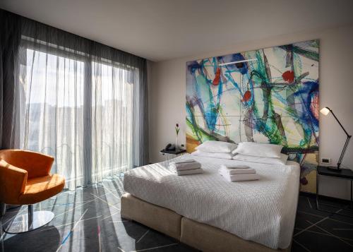 a bedroom with a bed with a large painting on the wall at Nobel Zira Hotel in Belgrade