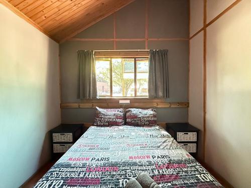a small room with a bed and a window at Hippo Waterfront Lodge in Nelspruit